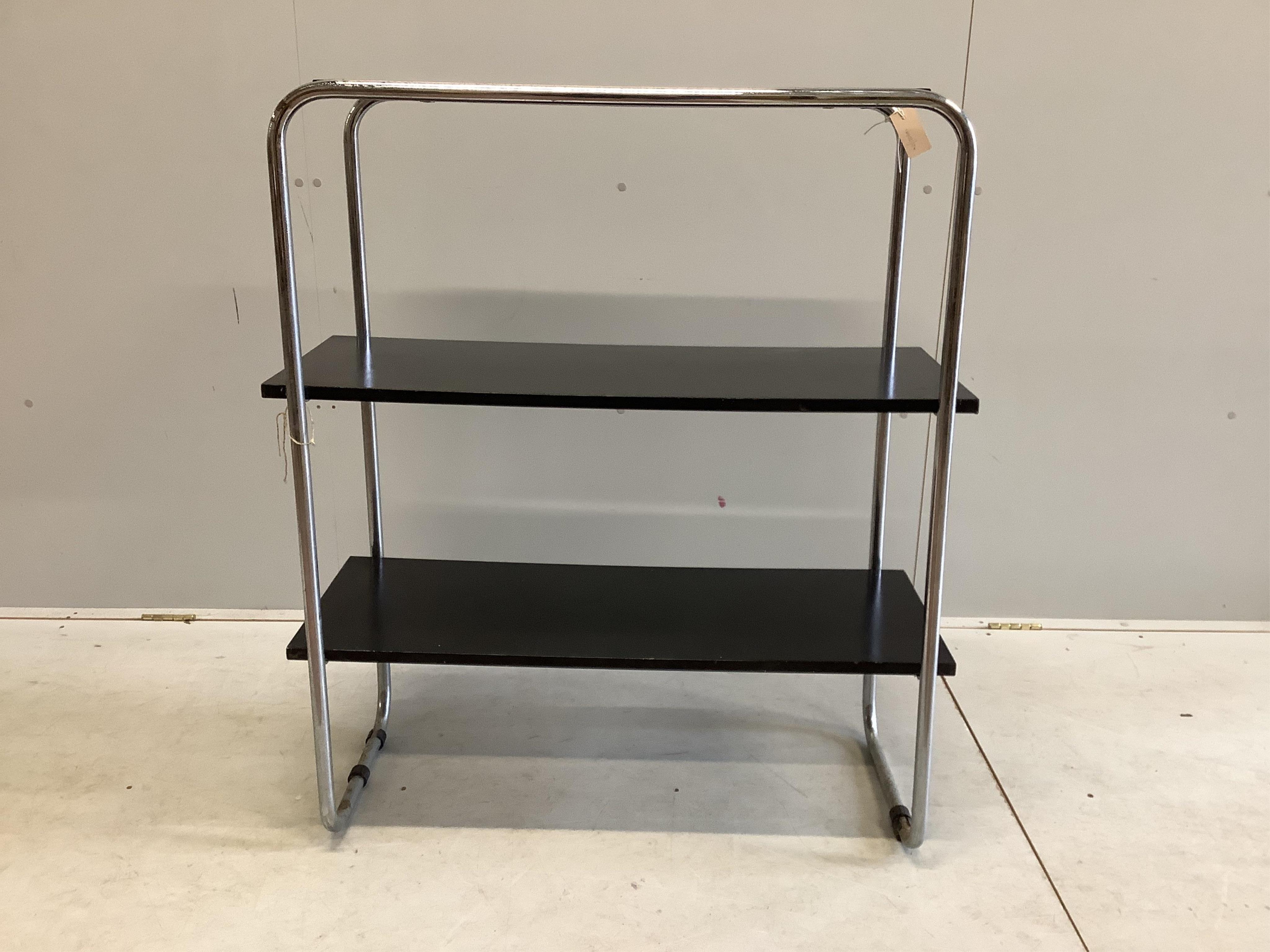 A mid century black lacquer and chrome three tier shelf unit, width 93cm, depth 38cm, height 107cm. Condition - poor to fair